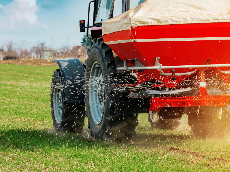 red tractor spraying field